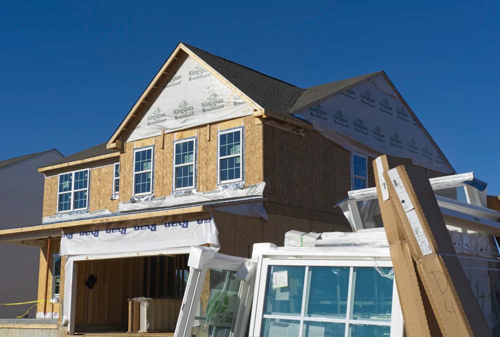 A new house under construction with windows being fitted